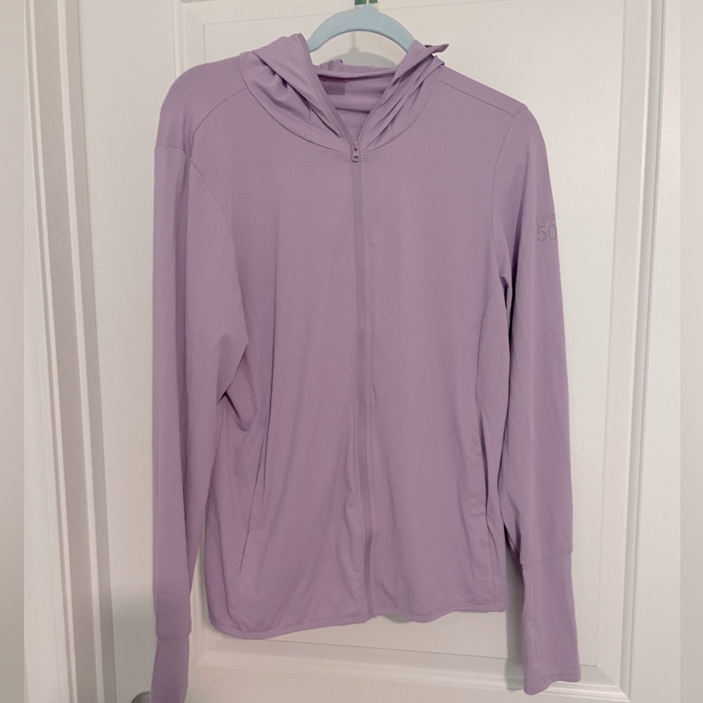 Ladies Jacket with built in cap. Front zipper with pockets.